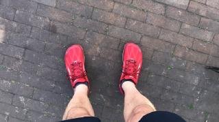 Looking down on red Altra Superior running shoes