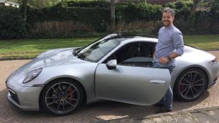 Bram posing in front of a Porsche Carrera 992 Carrera S